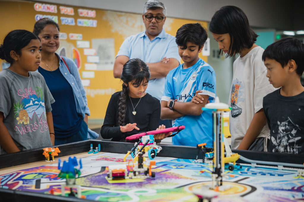 FLL students working together on a robotics project